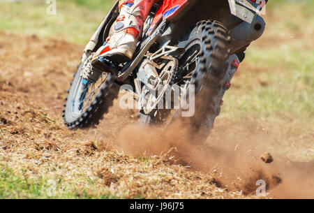 Professional motocross rider on the road. Back view. Stock Photo