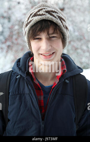 Portrait of Caucasian teenage boy in winter setting and warm clothing, UK Stock Photo