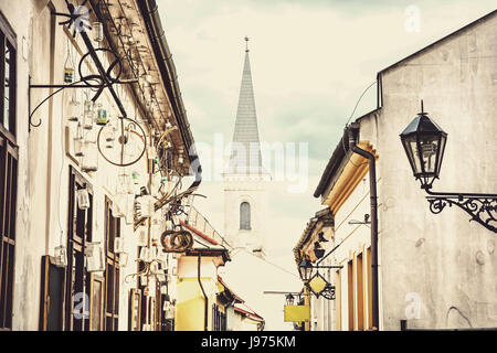 Hrnciarska street with Calvinist church in Kosice, Slovak republic. Folk art theme. Religious architecture. Buttercream photo filter. Stock Photo