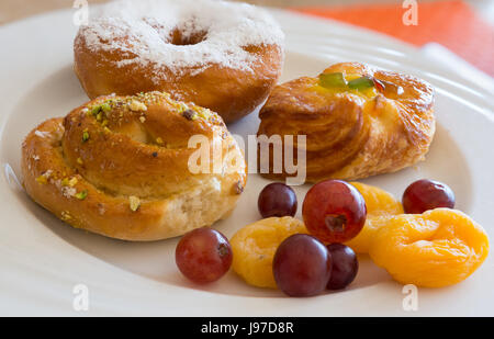 Danish pastry and  fruits on white dish,close-up. Stock Photo