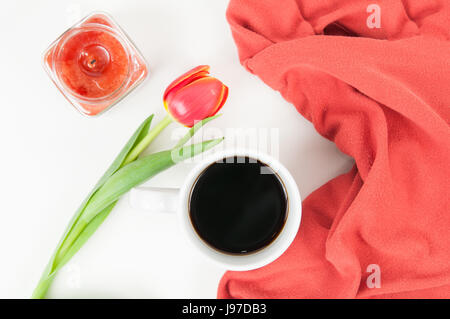 White desk top with various items on it with pops of orange colour Stock Photo