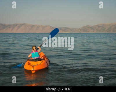 Girl (4-5) kayaking on lake Stock Photo
