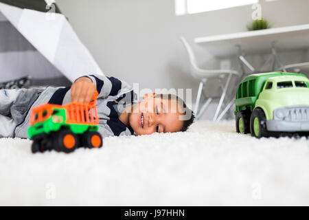 Boy (2-3) playing with toys in room Stock Photo