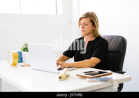 Mature woman working on laptop Stock Photo