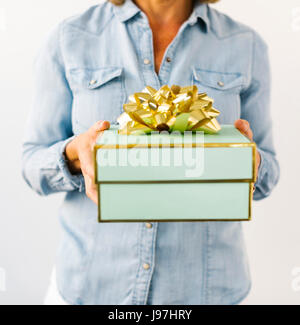 Mid section of Mature woman holding gift Stock Photo