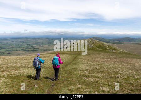 Two Walkers Heading Towards White Pike on the Lower Slopes of Clough Head, Lake District, Cumbria, UK Stock Photo