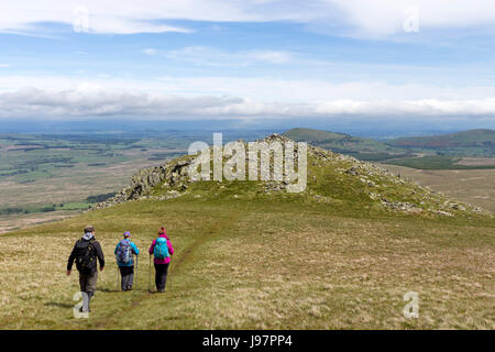 Three Walkers Heading Towards White Pike on the Lower Slopes of Clough Head, Lake District, Cumbria, UK Stock Photo