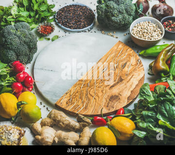 Vegetables, beans, grains, greens, fruit, spices over grey background Stock Photo