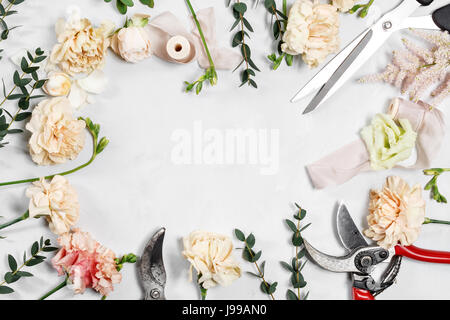 The florist desktop with working tools on white wooden background Stock Photo