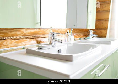 The bathroom in a rustic log cabin, in the mountains. with a beautiful interior. house of pine logs Stock Photo