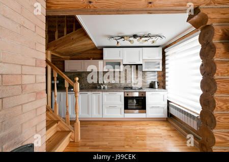 The kitchen room in a rustic log cabin, in the mountains. with a beautiful interior. house of pine logs Stock Photo