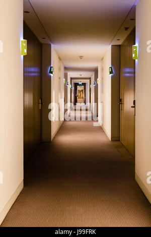 Room lights outside rooms along a corridor in a hotel. Stock Photo