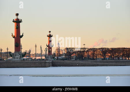 View of Arrow of Vasilevsky Island and Rostral columns from the Palace embankment in the winter in St. Petersburg Stock Photo