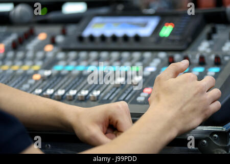 Director working on the video or sound mixing console in the studio Stock Photo