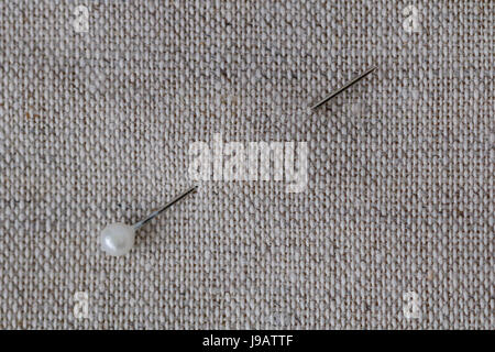 Close-up of sewing pin a linen cloth Stock Photo