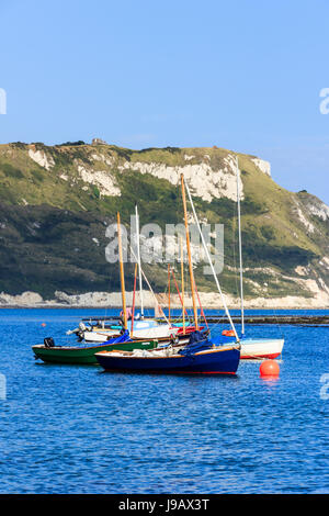Sailing boats moored on a calm blue sea at Ringstead Bay, Dorset, England, UK Stock Photo