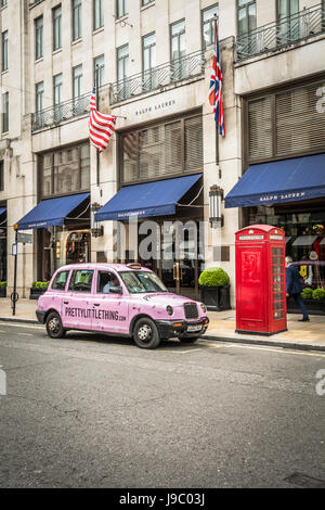 A Pretty Little Thing pink taxi parked outside the Ralph Lauren flagship store on New Bond Street, London, UK Stock Photo