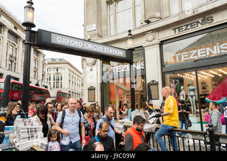 An Evening Standard newspaper vendor at Oxford Circus tube station, London, UK Stock Photo