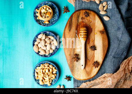 Honey dessert, nuts and honey on a rustic table, top view Stock Photo
