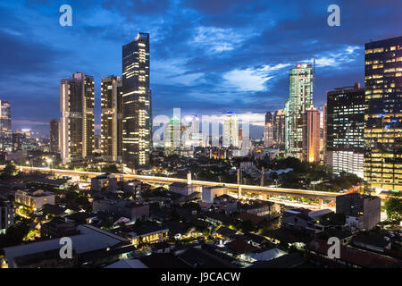 Aerial view of Jakarta business district, with many office and luxury residential buildings at night in Indonesia capital city. Jakarta is Southeast A Stock Photo