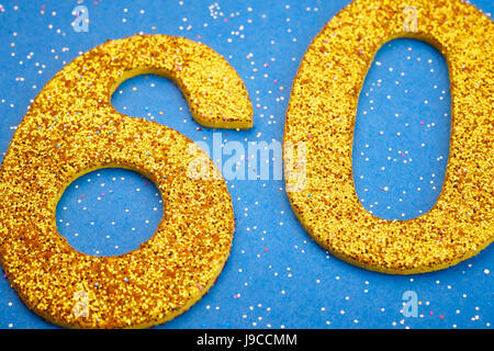 Number sixty yellow color over a blue background. Anniversary. Horizontal Stock Photo