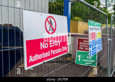 No Entry and warning signs on a metal fence on a building site. Stock Photo