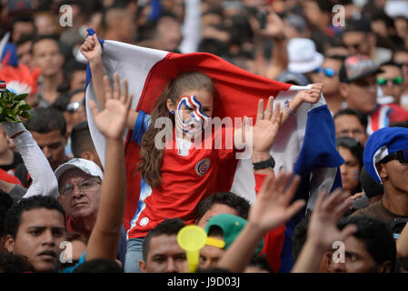 A young girl waves a Costa Rican flag in the Plaza de La Democracía in San José as their national team takes on Greece for a spot in the quarterfinals Stock Photo