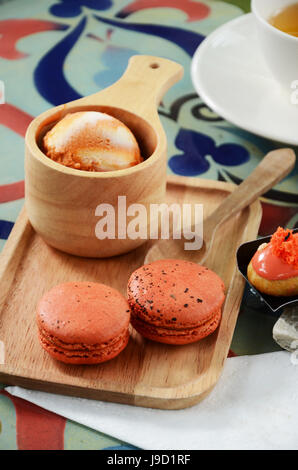 Green Tea with red bean roll cake and latte art on wood table. Stock Photo