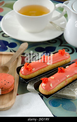 Green Tea with red bean roll cake and latte art on wood table. Stock Photo
