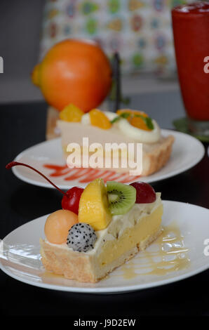 Green Tea with red bean roll cake and latte art on wood table. Stock Photo