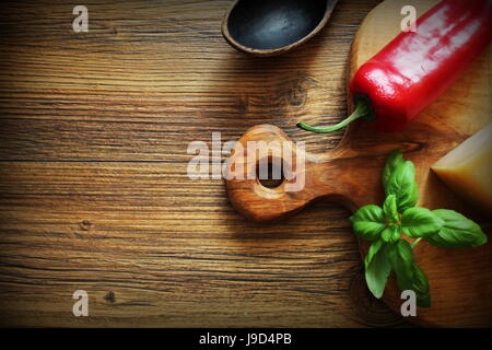 Ingredients for cooking food .Basil, cheese, pepper on wooden rustic background. Top view. Stock Photo