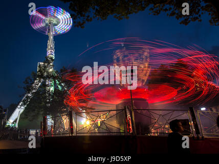 The light traces from 'Evolution' in the foreground and 'Air' in the background at St Giles fair, Oxford.  September 2012 Stock Photo