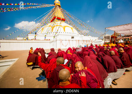 Buddhist monks praying around temple at Bouddha (Boudhanath), UNESCO World Heritage Site, Kathmandu, Nepal, Asia Stock Photo