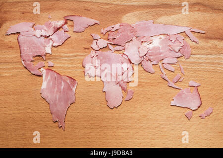 World map made from meat slices on wooden background Stock Photo