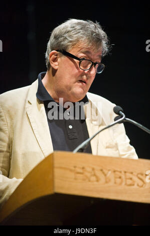 Stephen Fry reading from lectern at Letters Live event at Hay Festival 2017 Hay-on-Wye Powys Wales UK Stock Photo