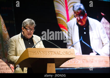 Stephen Fry reading from lectern at Letters Live event at Hay Festival 2017 Hay-on-Wye Powys Wales UK Stock Photo