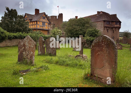 Medieval fortified manor of Stokesay Castle, showing the timber-framed gatehouse and the original 13th century castle, from the churchyard of St. John Stock Photo