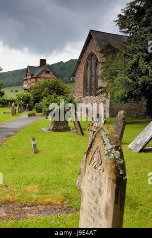Medieval fortified manor of Stokesay Castle, showing the timber-framed gatehouse and the church of St. John the Baptist, Shropshire Stock Photo