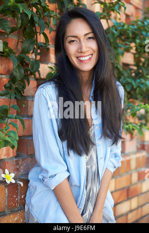 Mixed Race Asian Woman Looks To Camera Three Quarter Length Stock