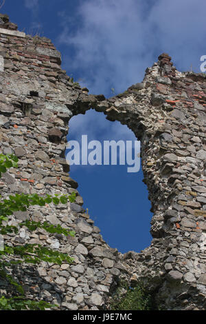big hole in the wall of destroyed ruined old medieval castle in Khust, Ukraine Stock Photo