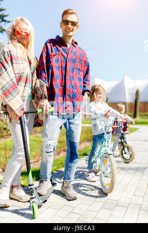 Family on bicycles in park Stock Photo
