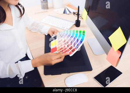 High angle view of a photo editor working at desk in creative office Stock Photo