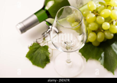 Empty wine glass and white wine bottle and grape Stock Photo