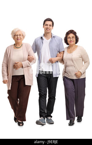 Full length portrait of a young man with two mature women walking towards the camera isolated on white background Stock Photo