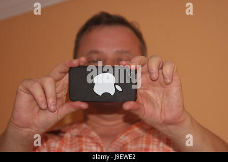 Man taking pictures with Apple iPhone Stock Photo