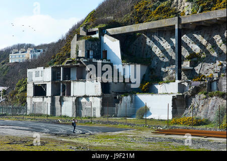 Woman taking pictures of the remains of Summerland building in Douglas, Isle of Man Stock Photo