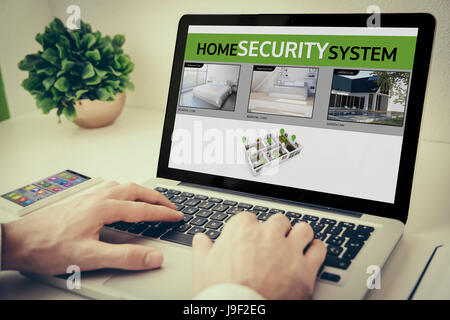 Hands using laptop on desktop with cctv Stock Photo