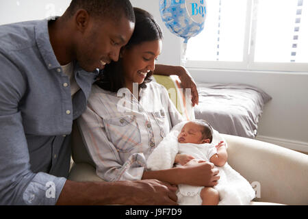 Parents Home from Hospital With Newborn Baby In Nursery Stock Photo