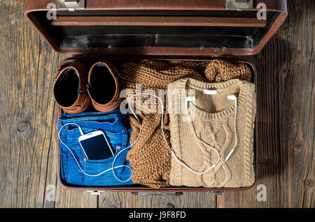 Retro suitcase with casual woman clothes Stock Photo