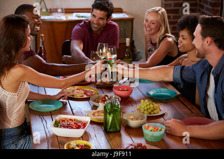 Six friends making a toast at a dinner party, elevated view Stock Photo